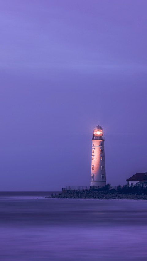 A lighthouse on the coast of the sea at dusk screenshot
