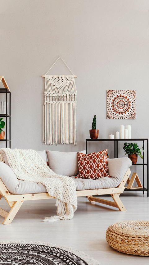 Blanket and cushion on couch in boho living room screenshot