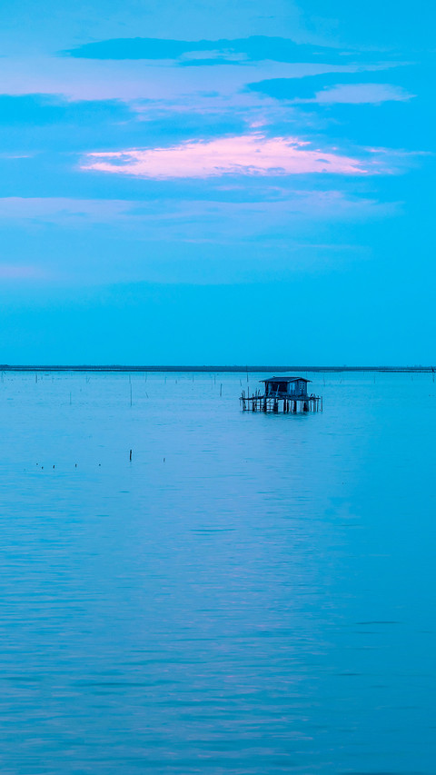 Beautiful twilight with fisherman house silhouette on sea screenshot