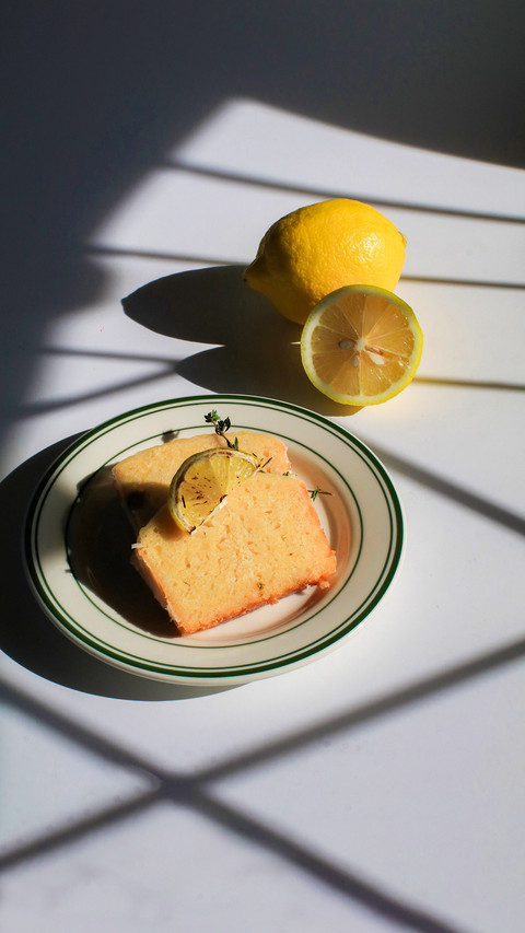 Homemade lemon cake on white, sunlit background screenshot