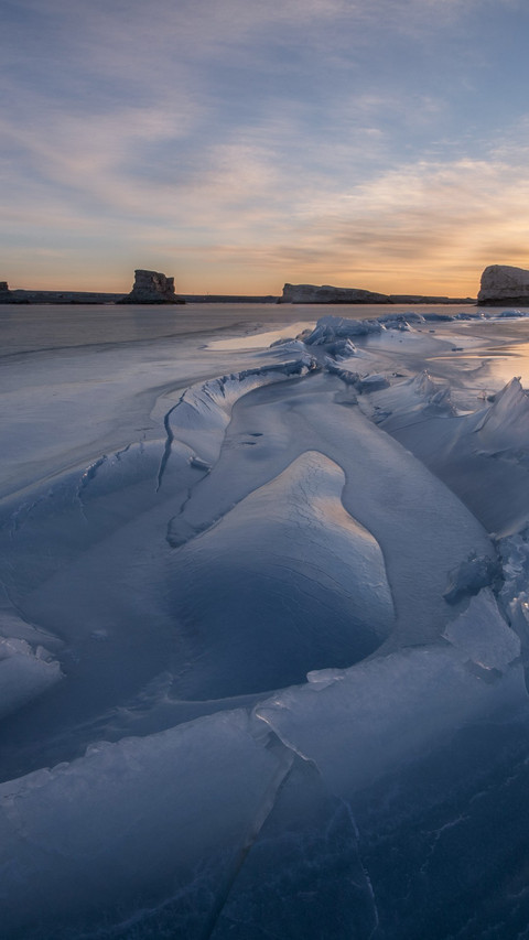 The frozen lake is still as a mirror's new surface. screenshot