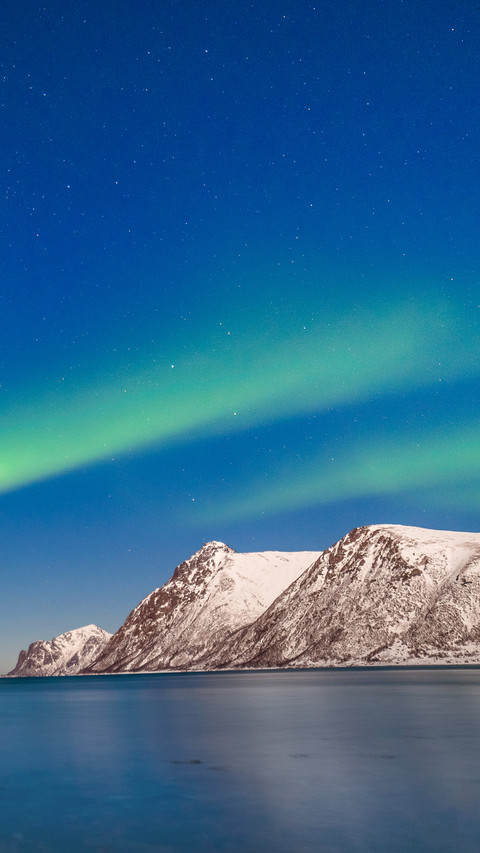 Polar lights over fjord mountains with many stars screenshot