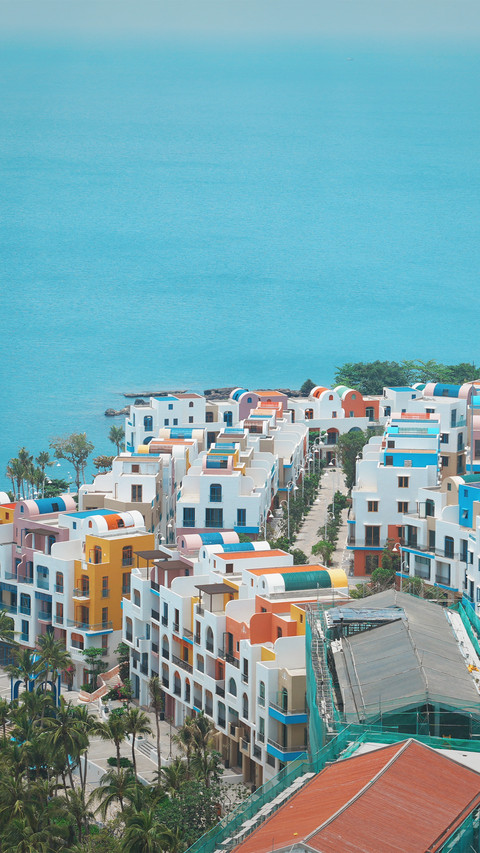 A group of seaside apartments with white walls and screenshot