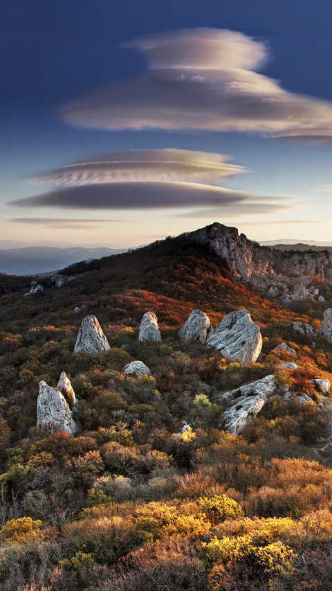 UFO-like clouds upon hills screenshot