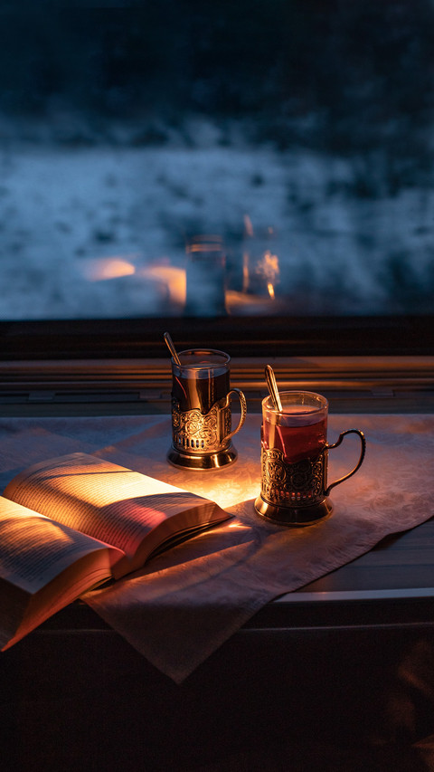 Cups of tea on the table in the train. Window. Evening screenshot