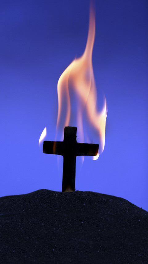 Burning cross on blue screenshot