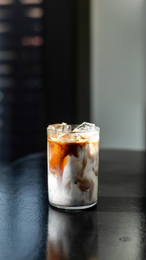 Iced coffee in glass on table in coffee shop blur background screenshot