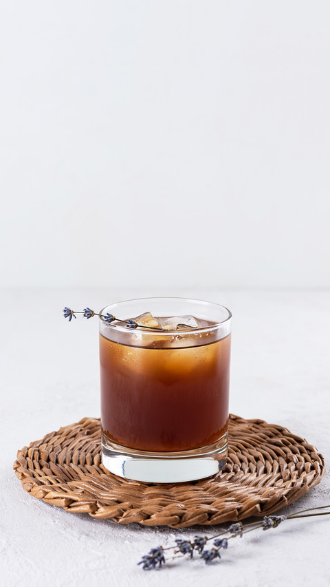 Cold drink with lavender in a glass on a light background screenshot