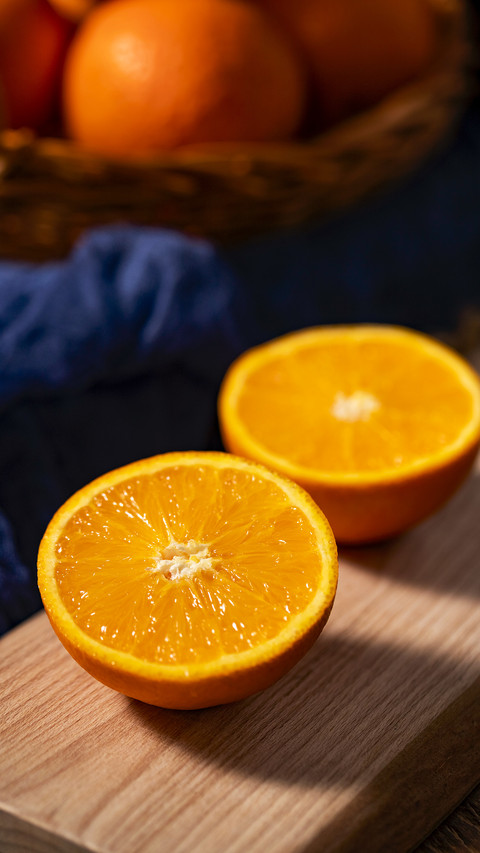 There is a sliced orange on the wooden table screenshot