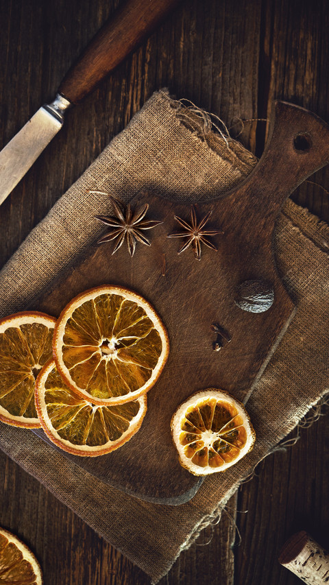 Dried oranges and spices on a wooned board screenshot