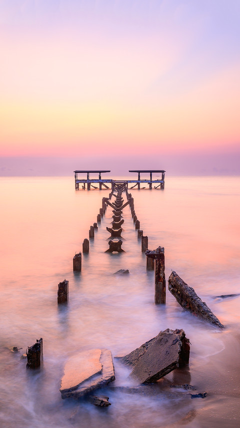 The old pier is in a decayed condition in the morning light screenshot