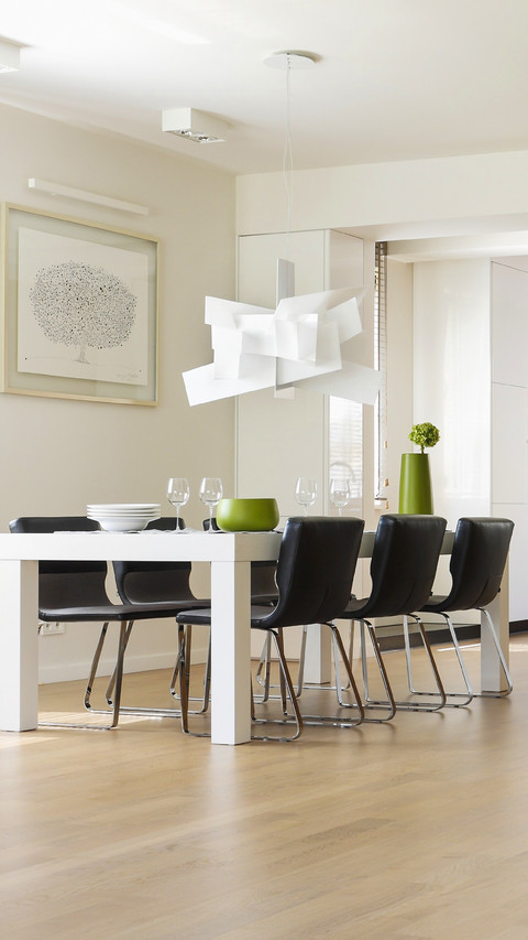 White dining table and black upholstered chairs in modern screenshot