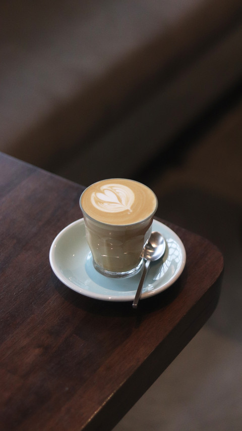 Latte art on te wood table in the coffee shop screenshot
