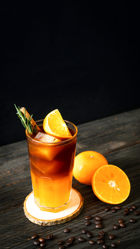 A glass of iced americano black coffee and layer of orange screenshot