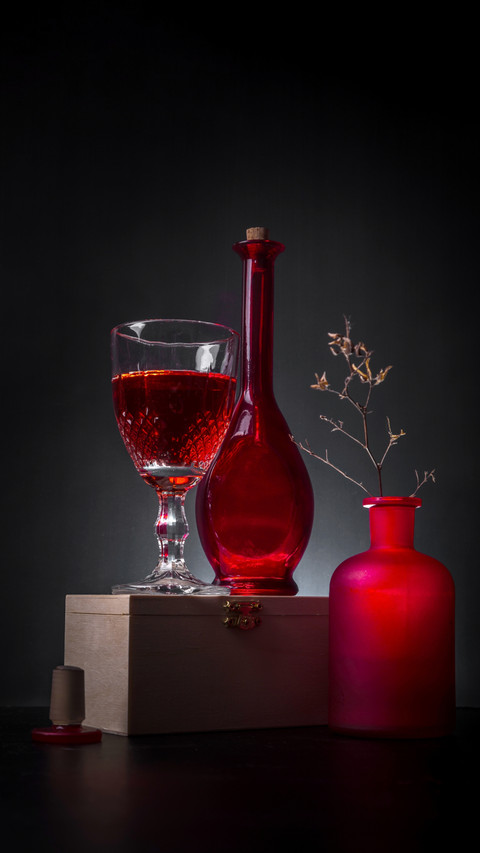 Elegant Still Life: Red Wine, Glass, and a Rustic Wooden Bas screenshot