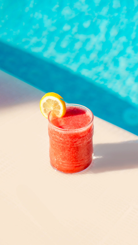 Ice cold red fruit cocktail by the pool screenshot