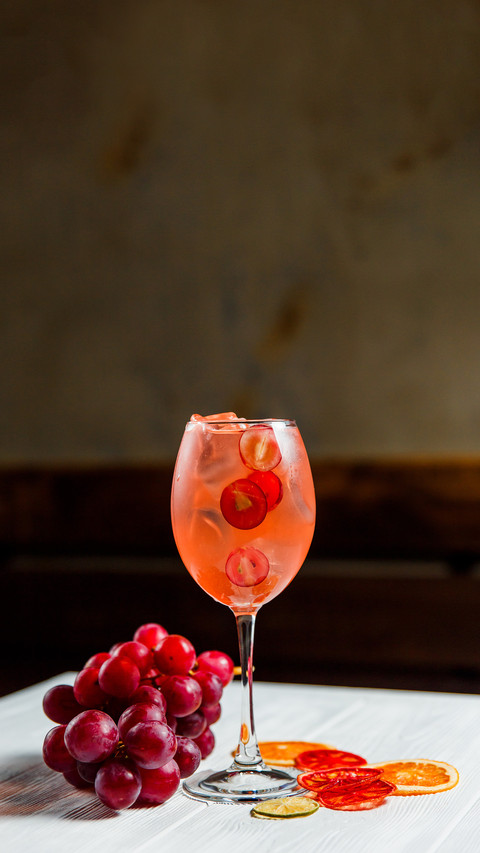 An orange cold summer alcoholic cocktail in a wine glass screenshot