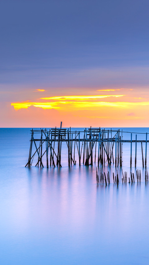 A sunset view of wooden fishermen jetty with nets screenshot