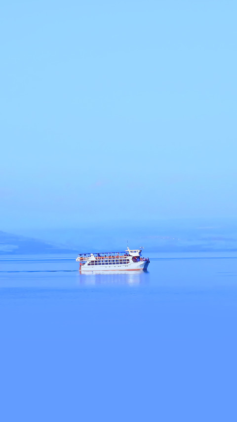 Cruise boat in middle of blue flat lake screenshot