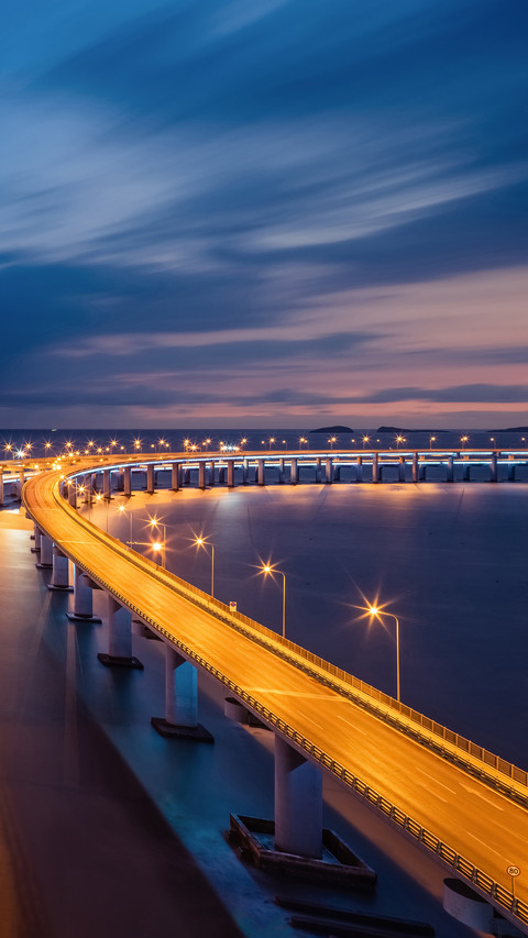 Cross sea bridge at night screenshot