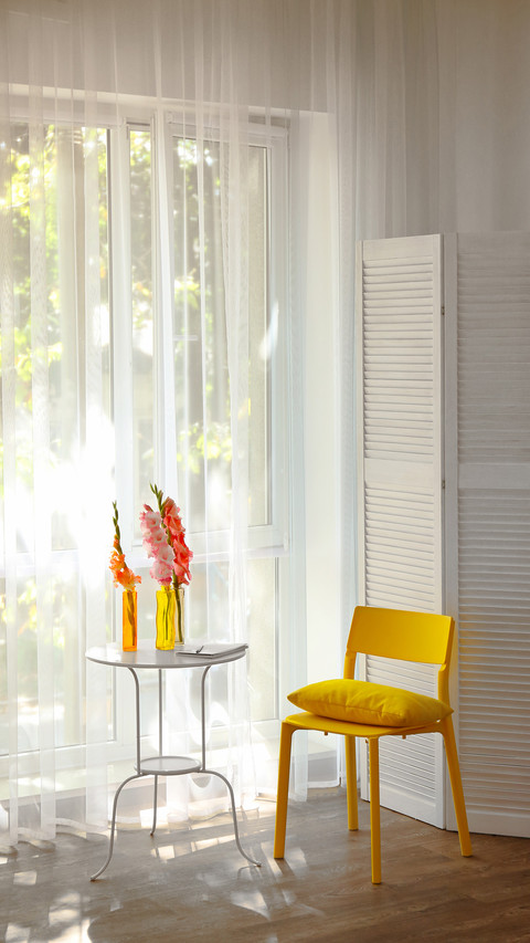 Yellow chair in a room with flowers screenshot