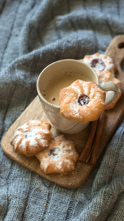 Biscuit chip cookies with jam and cup of coffee on wool knit screenshot