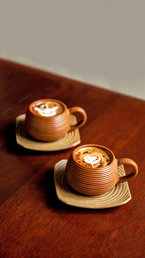 Two Brown Cups of Hot Cappuccino on Wooden Table screenshot