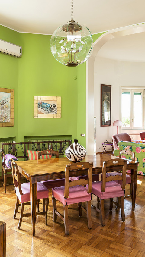 Dining table wooden chairs and green walls in front of screenshot