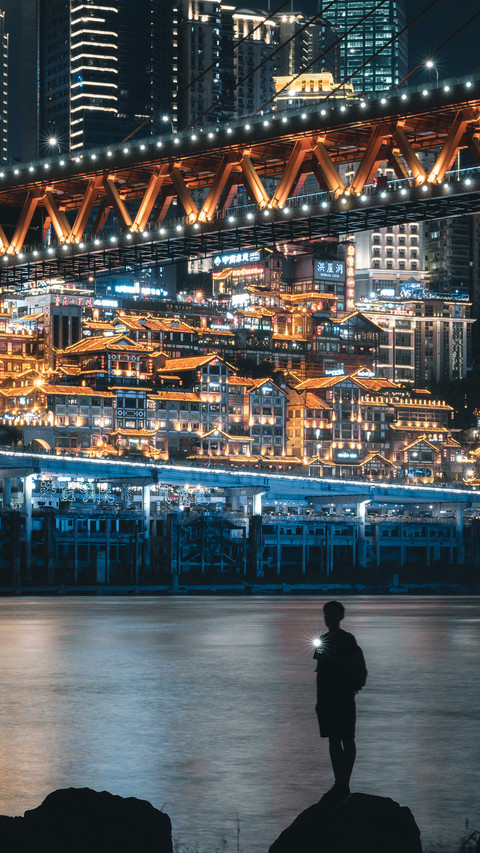 Man Standing by The River Under The Bridge at Night screenshot