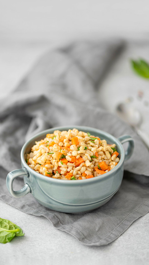 Boiled barley porridge with vegetables and spices in a plate screenshot