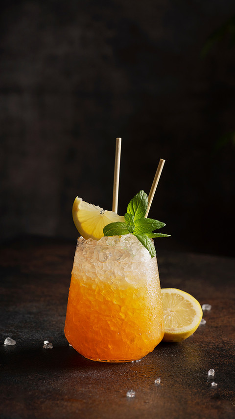 Cocktail with crushed ice, lemon and mint on dark background screenshot