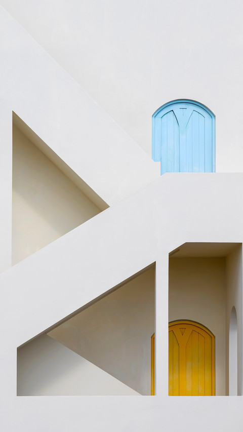 Two colorful doors on the side of a white building screenshot