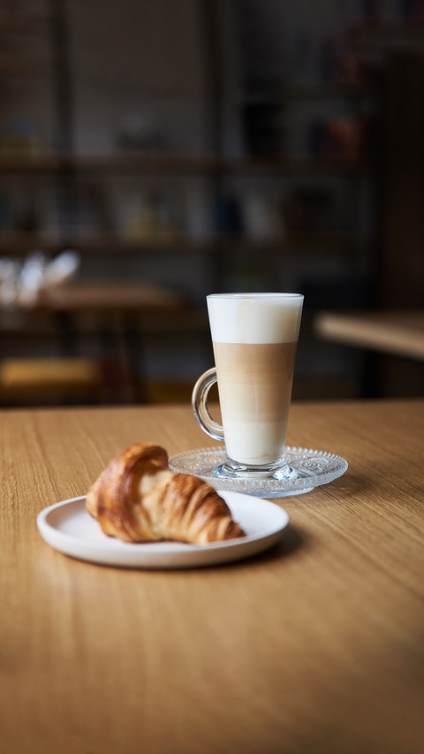 Coffee and croissant on the table screenshot