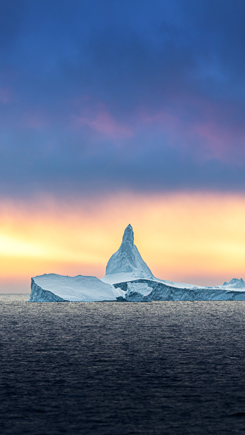Iceberg ice formation in front of midnight sun in Antarctica screenshot