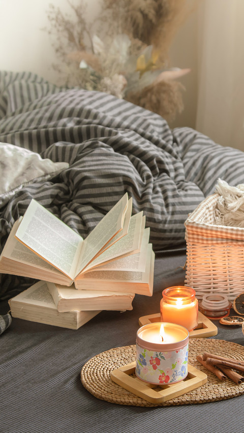 Candles and a Book Lie on the Bed in the Living Room screenshot