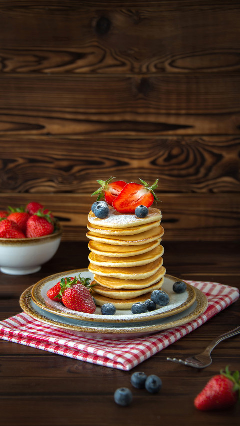 Blueberries and jars of berries on wooden background screenshot
