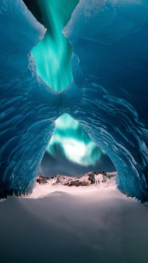 Person in the Middle of Ice Cave with Aurora screenshot