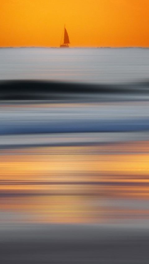 Seascape sailboat under an orange sky screenshot