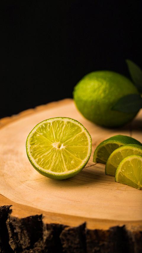 Fresh ripe limes on wooden background screenshot