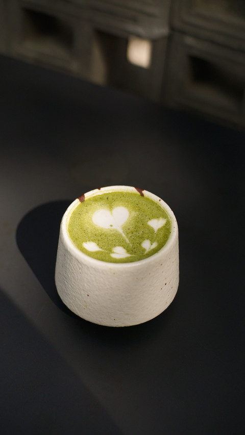 Hot green tea latte with heart and love latte art in a cup screenshot