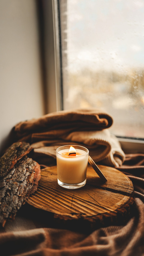 Burning candle in home interior, autumn aesthetics screenshot