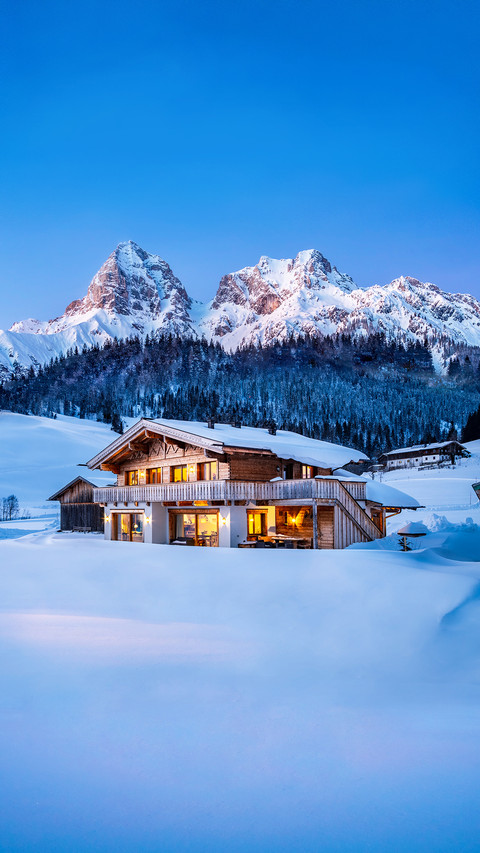 Wooden Chalet in The Alps On A Cold Winter Evening screenshot