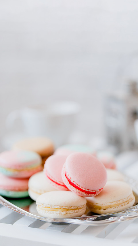 Colorful french macaroons on steel tray screenshot