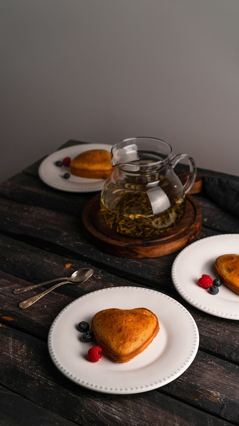 Heart-shaped cake and berries dessert on white plate against screenshot