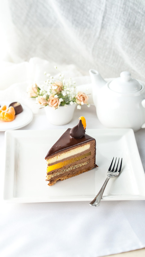 Slice of cake with Chocolate Glaze and orange on plate screenshot