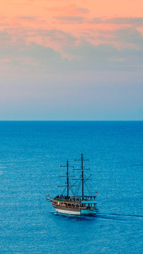 Touristic boat tour on the sea at sunrise time screenshot