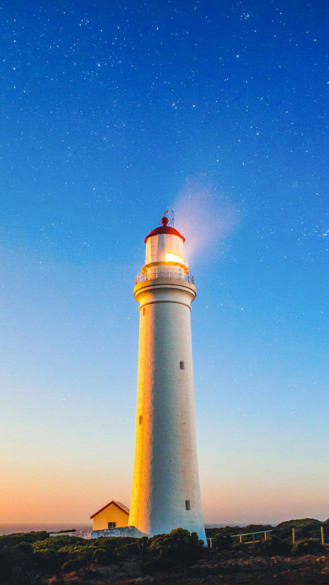 Lighthouse seaside with stars and sunset screenshot