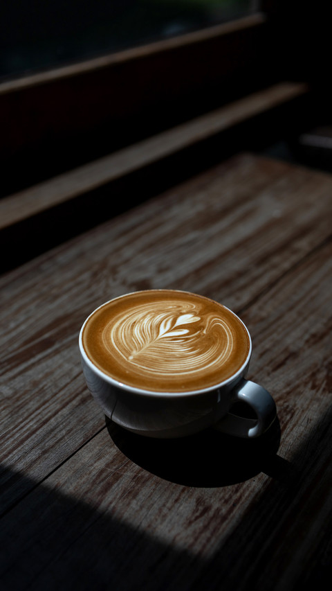 Coffee latte art on wooden bar background screenshot