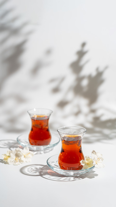 Turkish Tea in Traditional Glass Closeup on White Background screenshot
