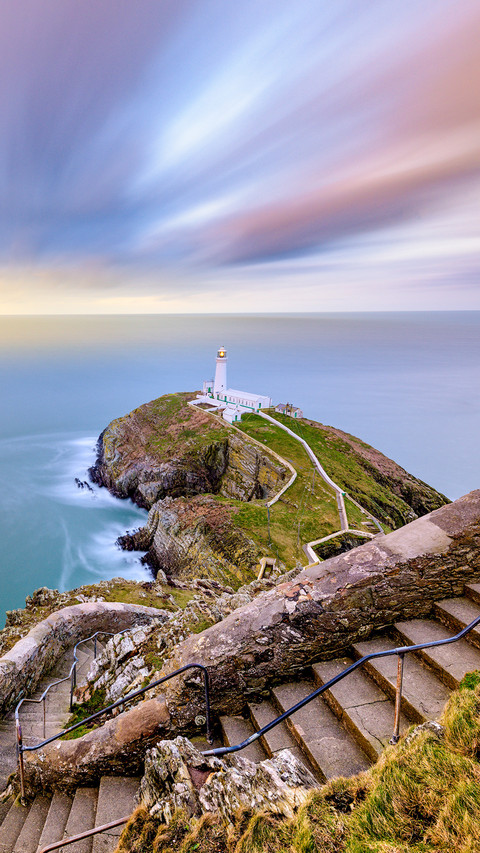 Stairs to lighthouse overlooking sea sunrise screenshot